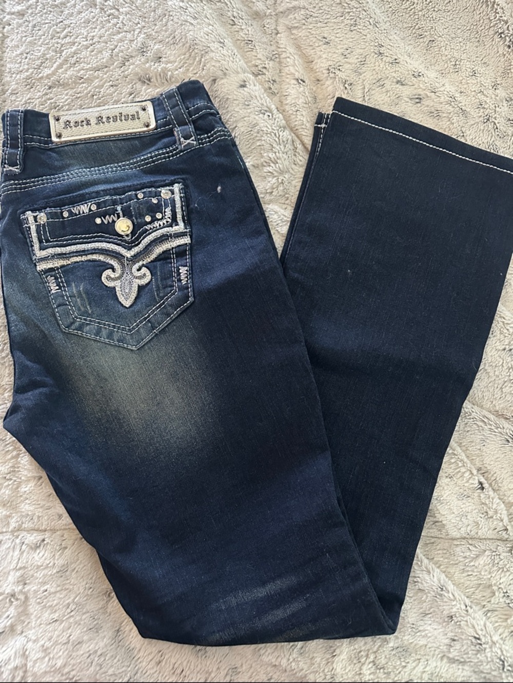 Rock Revival Dark Indigo Bootcut Jeans with Embroidered Pocket.